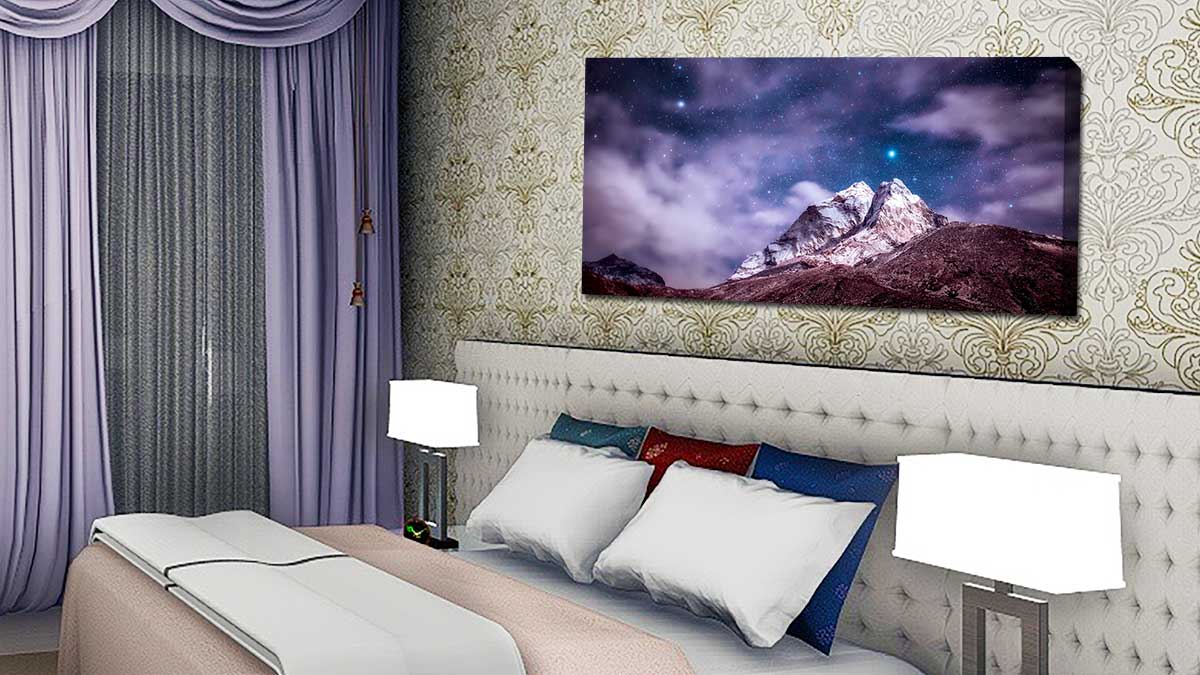 Snowcapped mountain printed on canvas and hung in a bedroom
