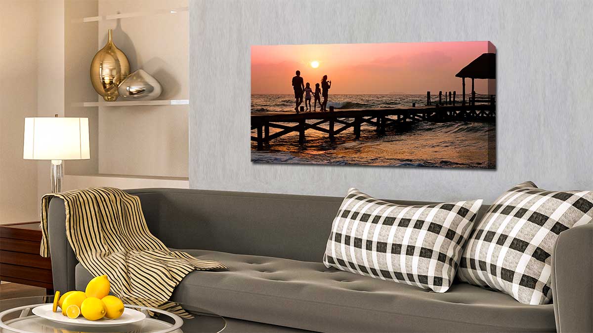 Canvas of a family standing on tropical jetty in the sunset