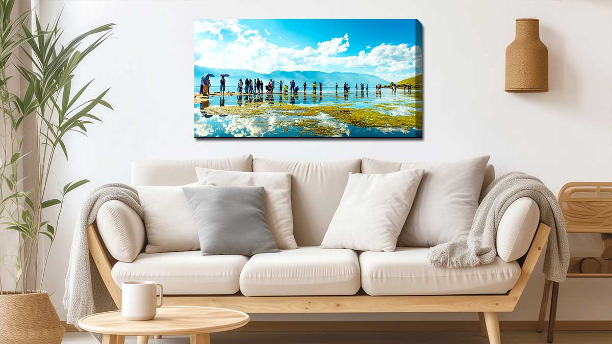 Stylish sitting room with a canvas print depicting a misty sunset in a wintry woodland.