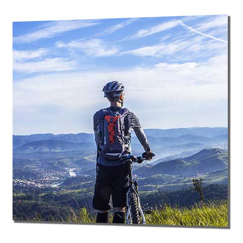 Square framed poster of a cyclist overlooking a picturesque mountain range