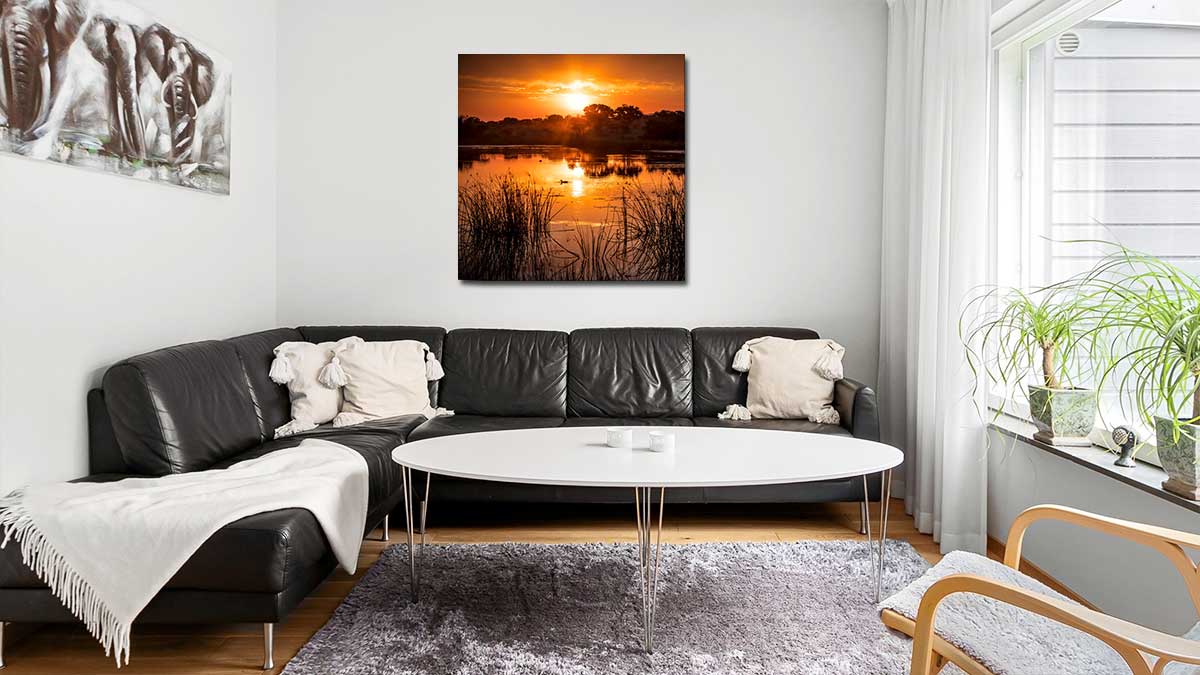 Spectacular sunset photo printed on a square poster and hung on the wall in a casually atmosphered sitting room