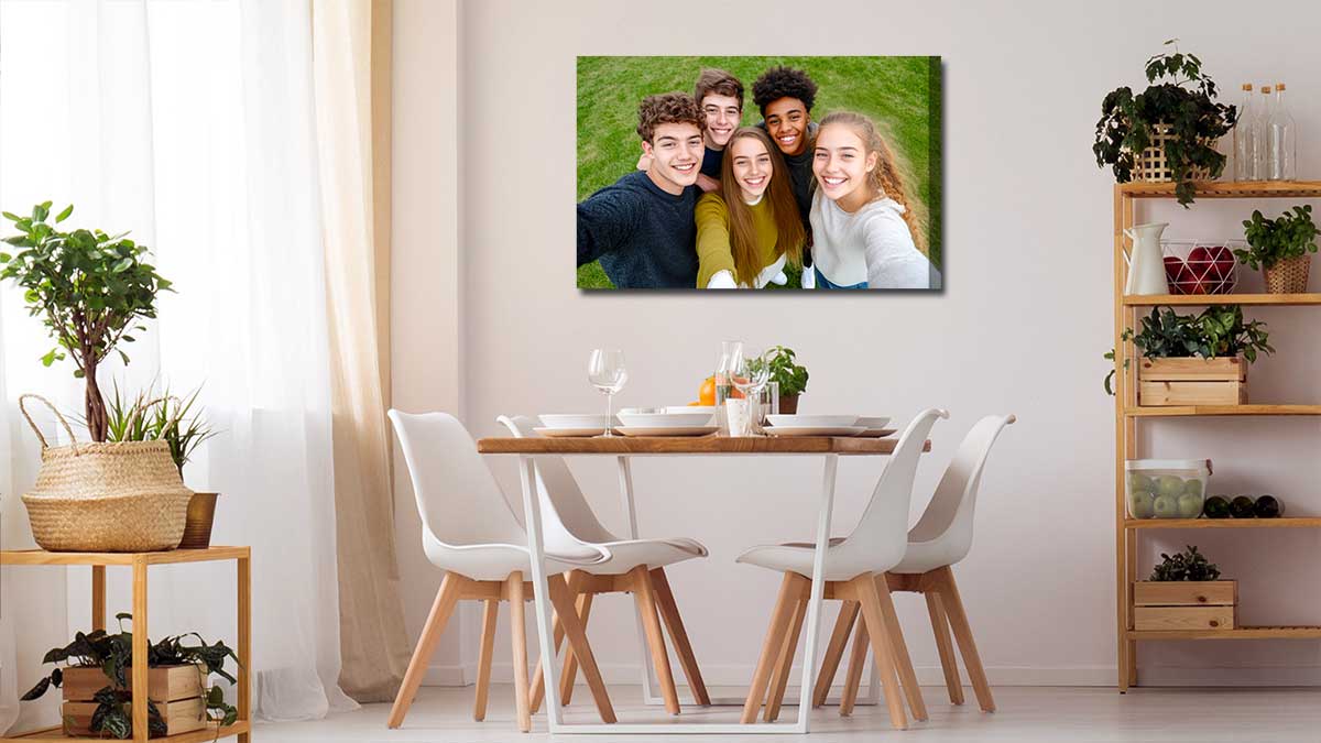 Canvas print of group of friends taking a selfie and hung on a wall by the dining room table