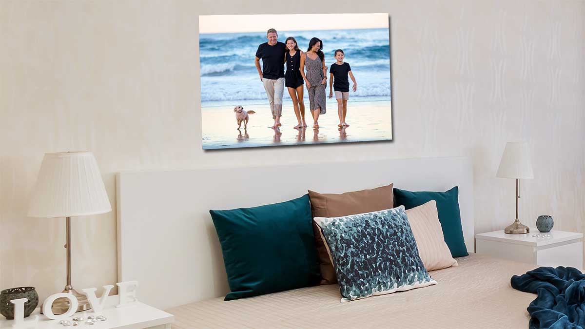Photo of a family enjoying a day at the seaside hanging on a bedroom wall