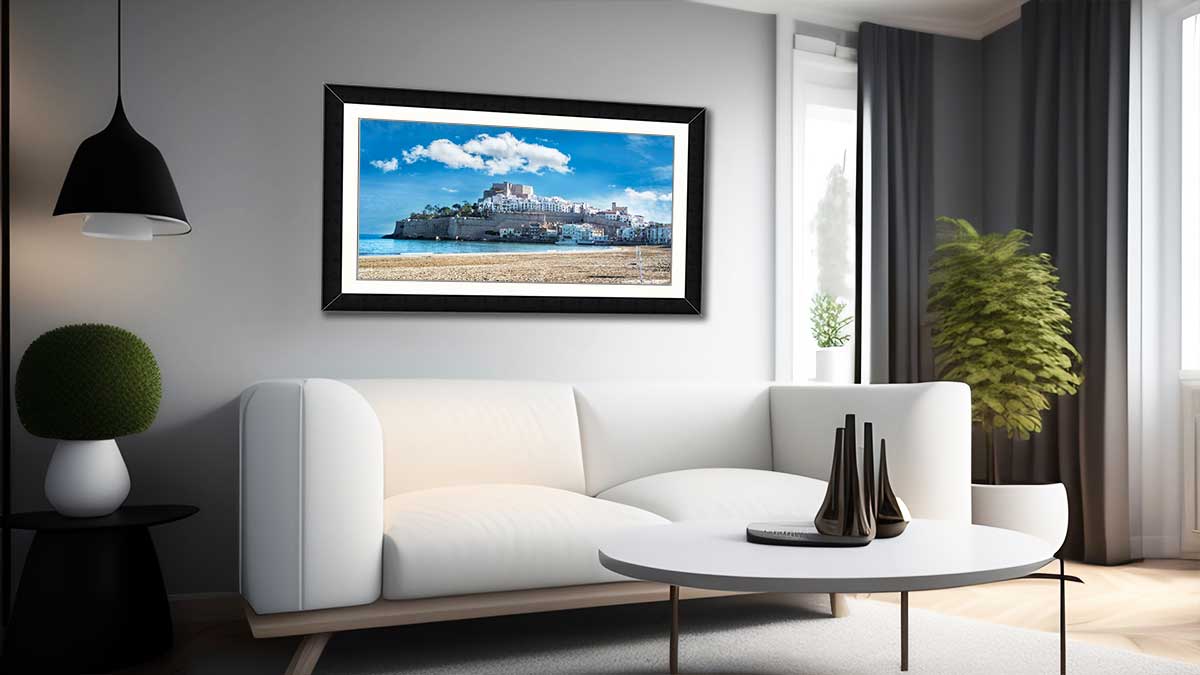 Sweeping cityscapes of an island city, printed poster in a simple black frame and hung over a settee