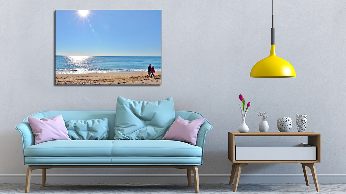 A1 poster of a pristine seaside hung over a modern settee