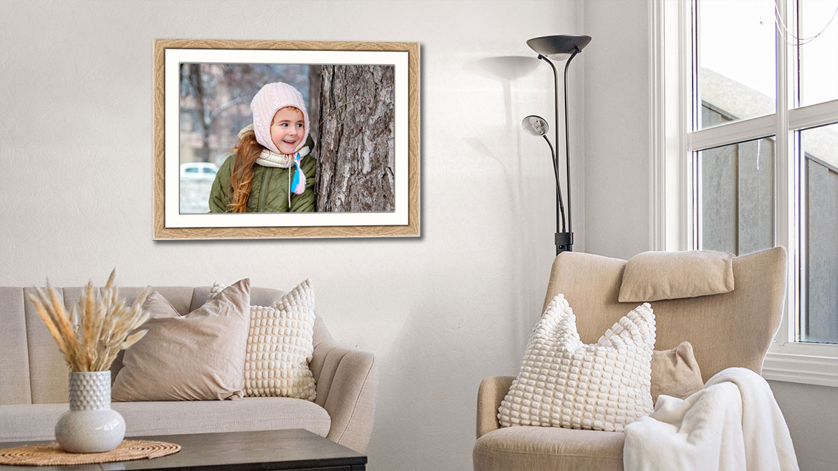 Photo print and frame of a young girl framed in a beautiful oak frame in a tastefully decorated sitting room
