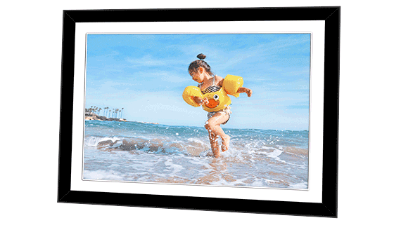 Framed poster featuring a photo of a young girl playing in the sea