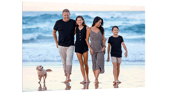 Family photo featuring a day at the seaside with their dog