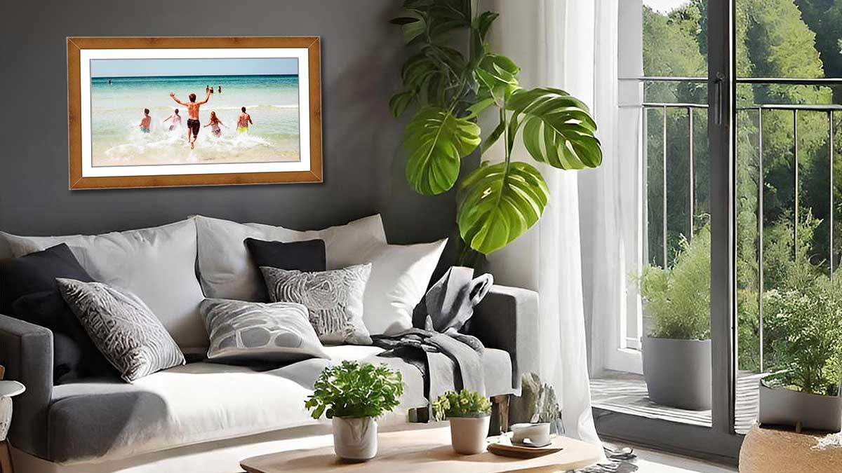 Framed poster featuring a seascape with young adults frolicking in the waves, hung in a modern sitting room